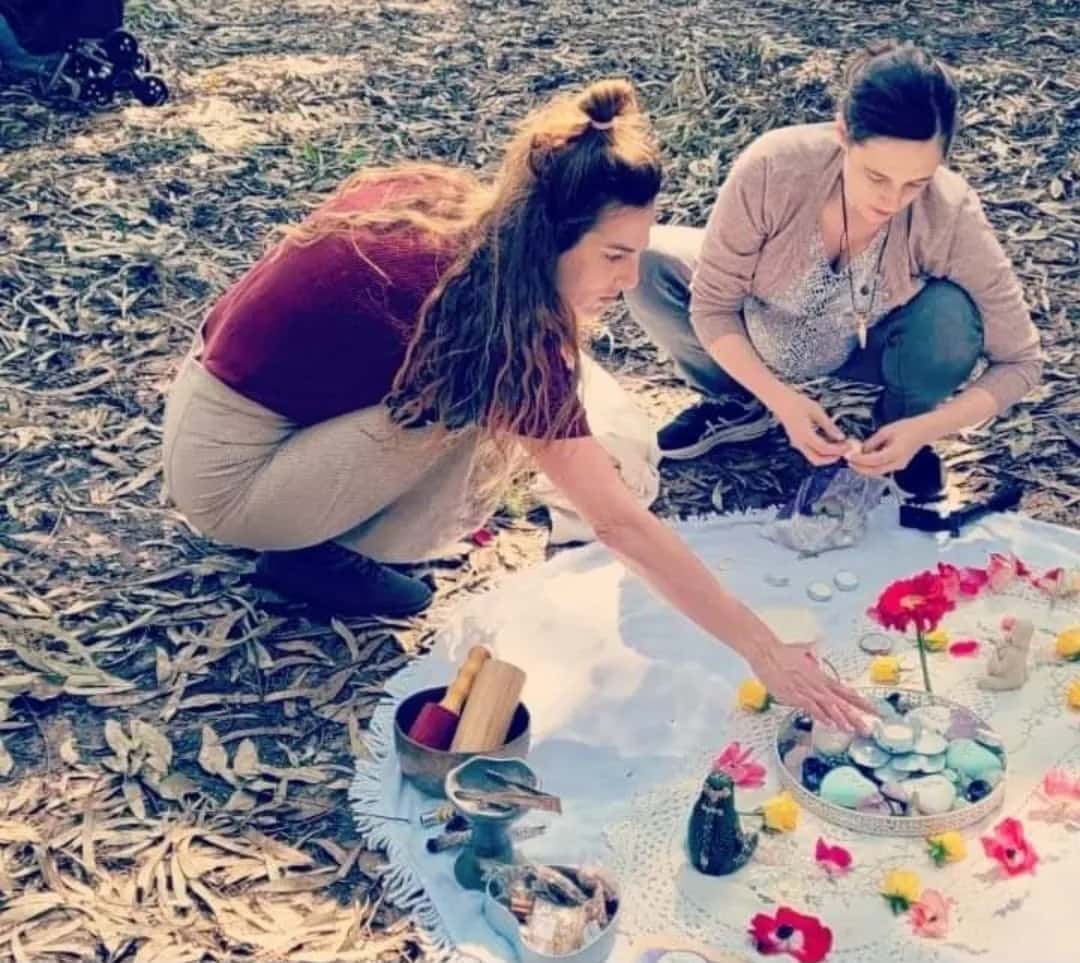 עדי אור ברכה מסדרת מנדלה של פרחים ואבנים יחד עם משתתפת, בטבע